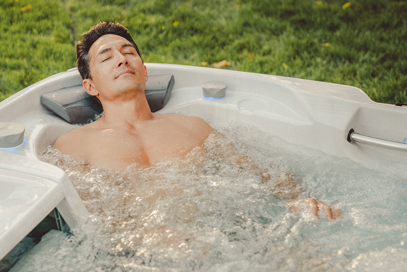 Man enjoying his Sundace Spa - hot tub summer care tips free water test Main Street Pool & Spa