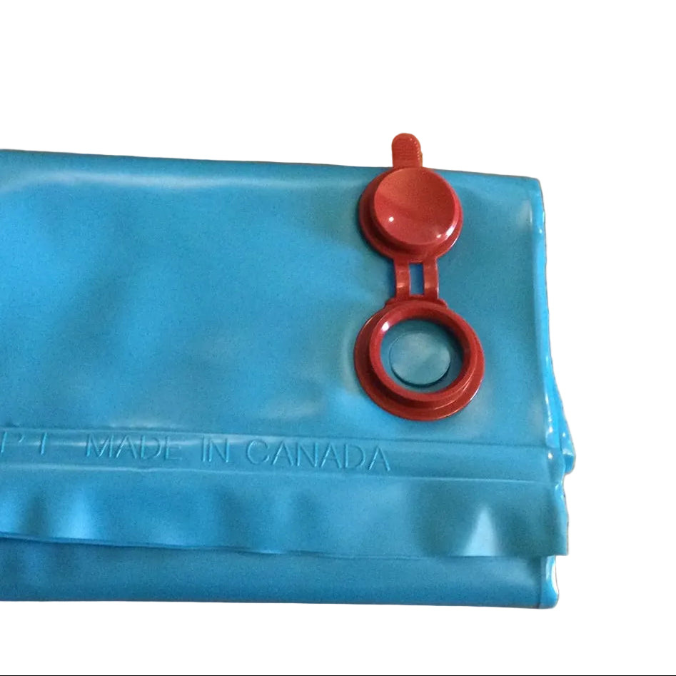 A blue water bag with a red cap on a table, with the text 'MADE IN CANADA' visible on the bag.